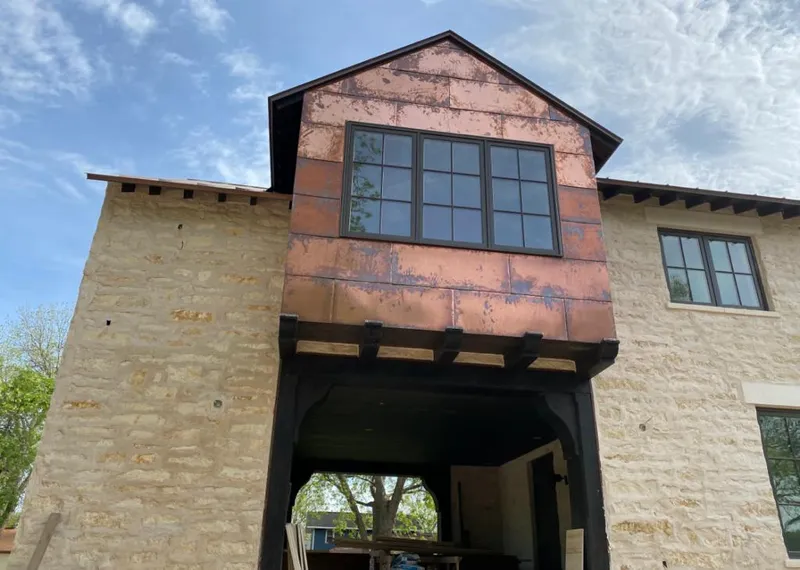 Copper metal panel facade on a stone building for Metal Roof Coating in Fort Lupton