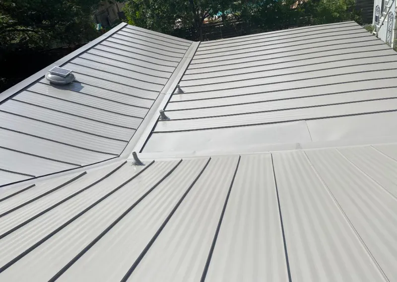 Solar attic fan installed on a metal roof for Roof Ventilation in Fort Lupton